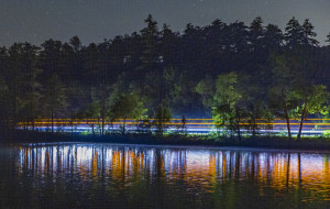 Light streaks of blue and orange reflect in the water.